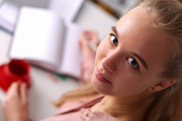 Top view of beautiful businesswoman  with gladness and smile. Cheerful businesslady having break at workplace. Business and company concept