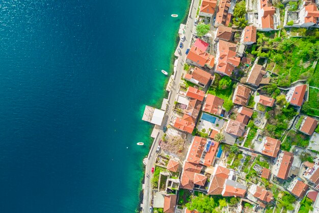 Top view of a beautiful city with red roofs near the sea