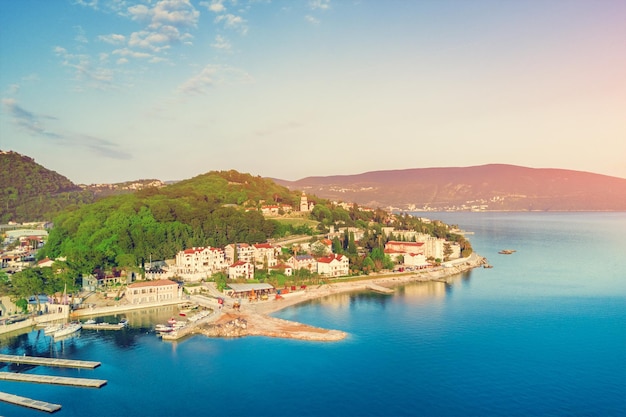 Top view of beautiful city with a sea port at sunset