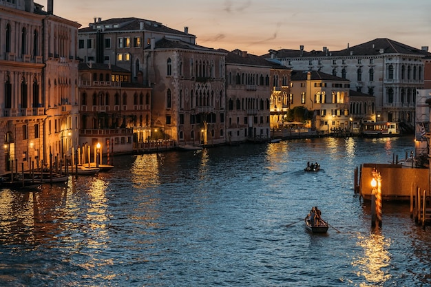 Top view of the beautiful grand canal in venice with glowing lights on the blue sky on a summer