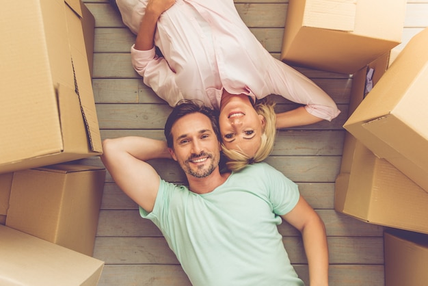 Top view of beautiful mature couple is lying on the floor.