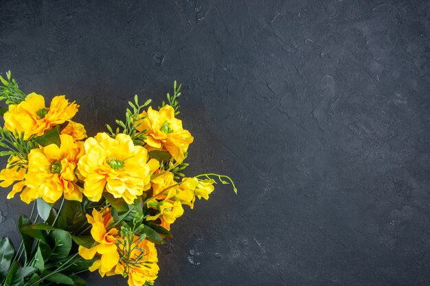 top view beautiful yellow flowers on dark surface