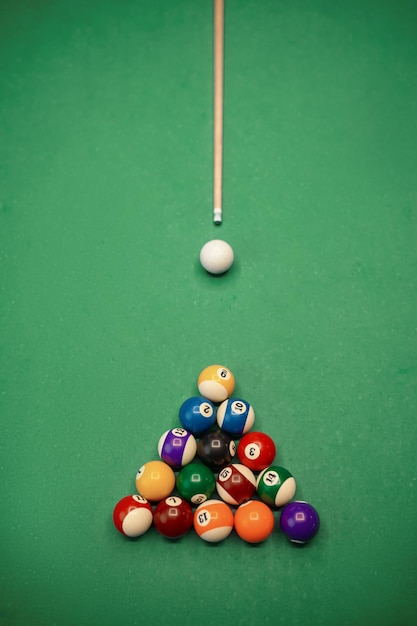 Top view on billiard ball and cue