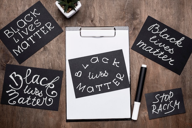 Top view of black lives matter cards with clipboard