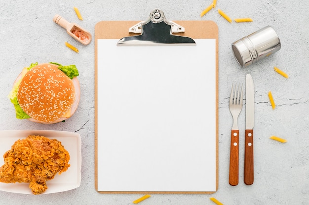 Top view of blank menu with burger and fried chicken