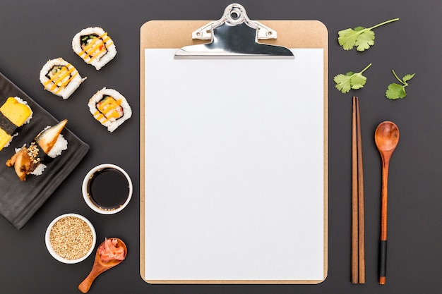 Top view of blank menu with sushi and soy sauce