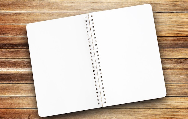 Top view blank paper notepad on wood table background