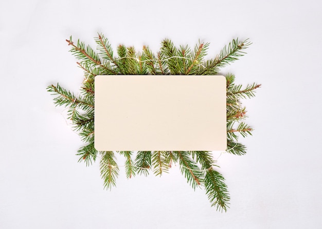 Top view of blank paper with spruce branches