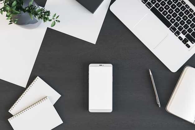 Top view on blank white modern smartphone screen with laptop notebooks men and papers on black table 3D rendering mockup