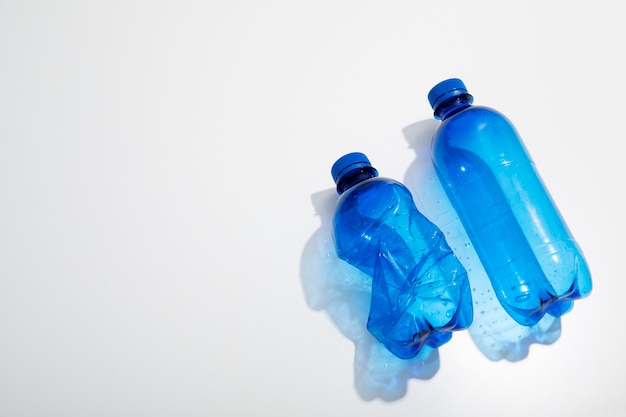 Top view blue plastic bottles with copy space