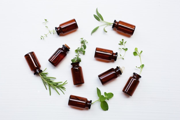 Top view, Bottle of essential oil with herbs