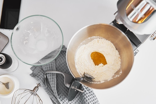 Top view of bowl with flour and ingredients on table