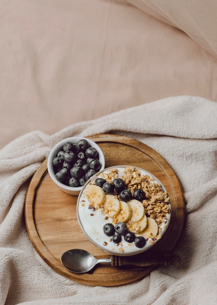 Top view of breakfast in bed with cereal and banana