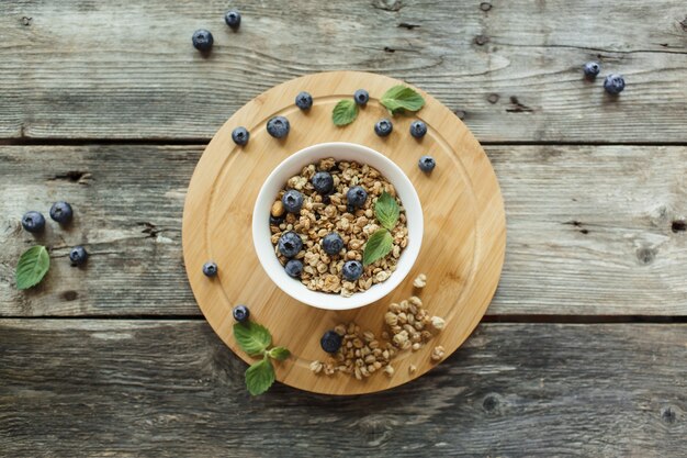 Top view breakfast with muesli fresh berries on wood background