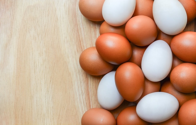 top view of brown chicken eggs and white duck eggs on wooden  background