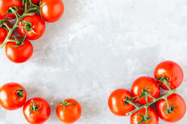 Top view of bunch of fresh tomatoes on grey texture