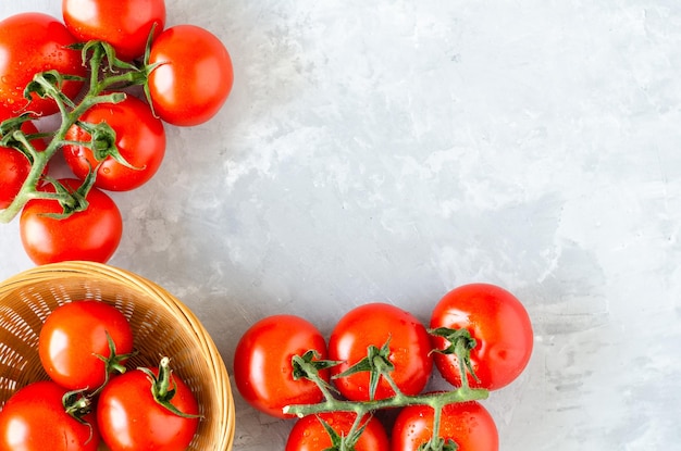 Top view of bunch of fresh tomatoes on grey texture