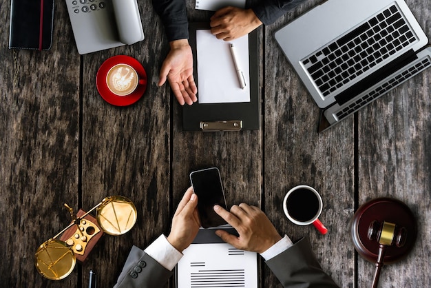 Top view Business and lawyers discussing contract papers with brass scale on desk in office Law legal services advice justice and law concept xA