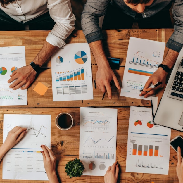 Top view of business professionals analyzing graphs charts and financial data together