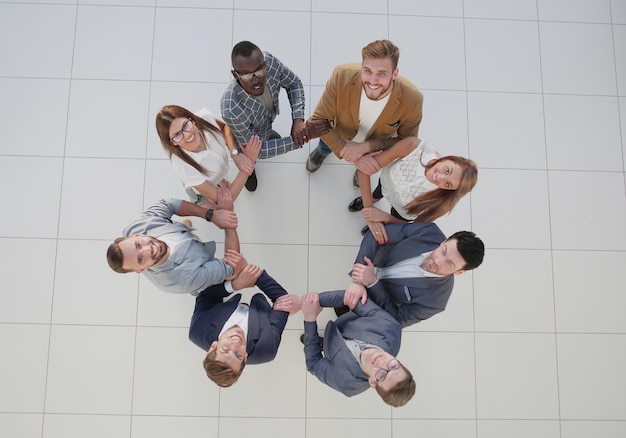 Top view.the business team holds each other's hands.the concept of team building