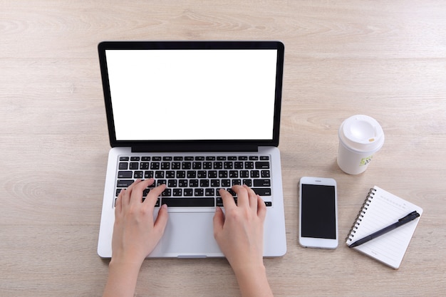 Top view business woman laptop with blank screen and smartphone