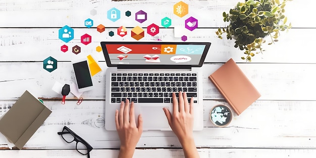 Top view of businesswoman working on laptop at office desk with business icons