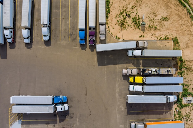 Top view car parking truck stop on rest area in the highway trucks stand in a row