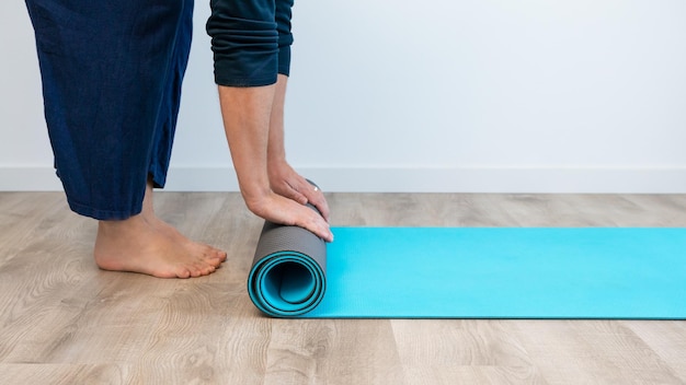 Top view of caucasian man with exercise mat preparing for yoga sports training in the house indoor Meditate and fitness workout exercises at home