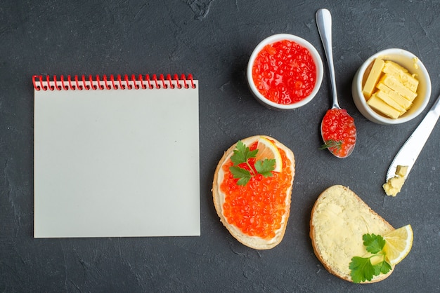 top view caviar sandwiches with lemon and cheese on dark surface