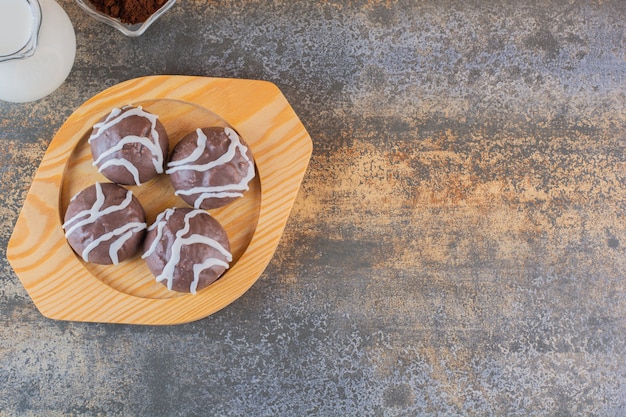 Top view of chocolate cookies on wooden plate