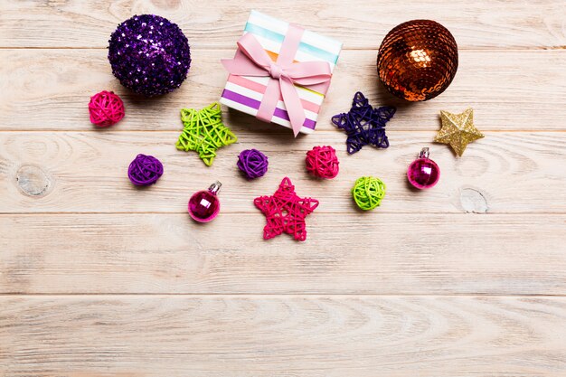 Top view Christmas ball, gift and creative decorations on wooden background