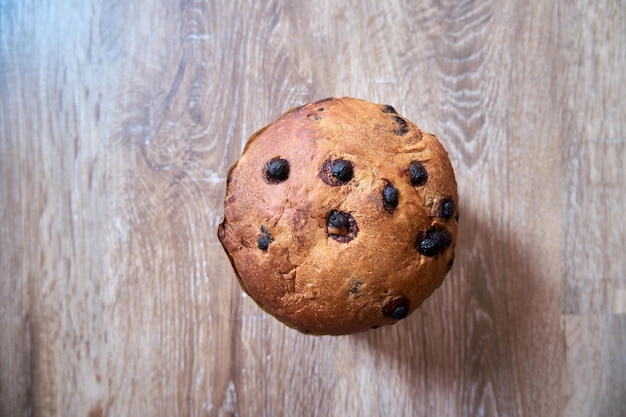 Top view of Christmas Chocolate Cake Panettone On Wooden Background with copy space on selective focus