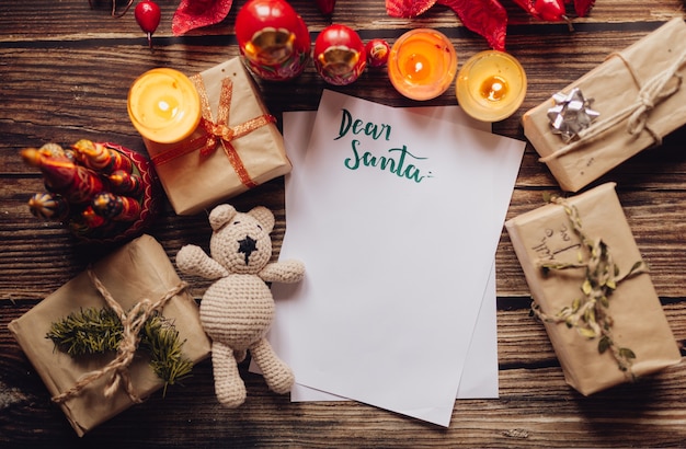 Top view Christmas letter surrounded by presents