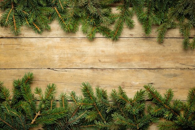 top view Christmas tree branches on wooden table