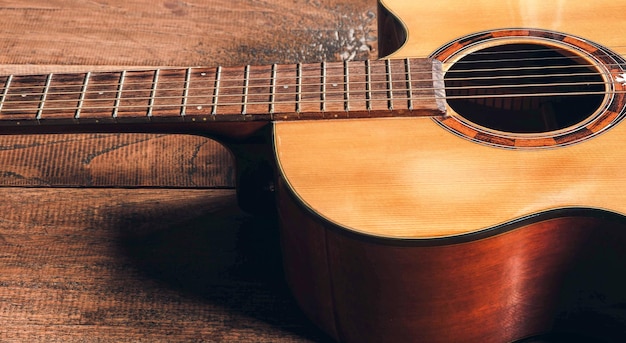 Top view of classical guitar on old wooden backgrounddark tone