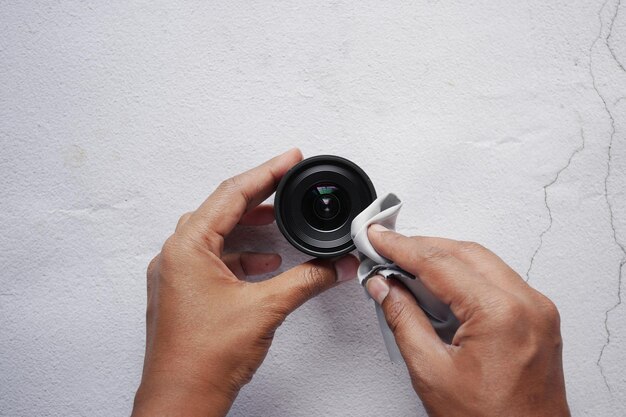 Top view of cleaning a camera lenses with a cleaning cloth