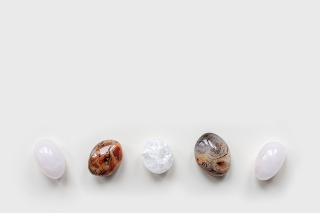 Top view close up colored pebbles stones on white background Row from natural round smooth stone