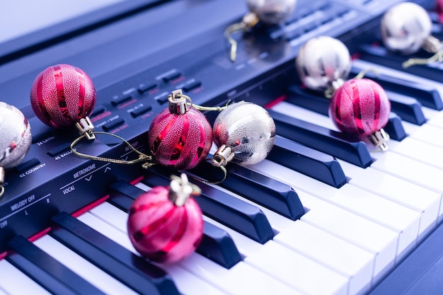 Top view close up shot of piano keyboard and Christmas decoration