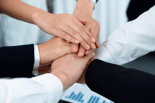 Top view closeup business team join hand stack together for harmony concept