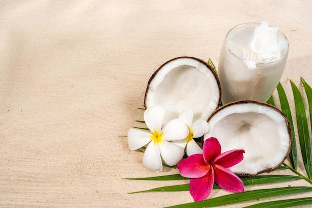 top view coconut drink on sand beach background.