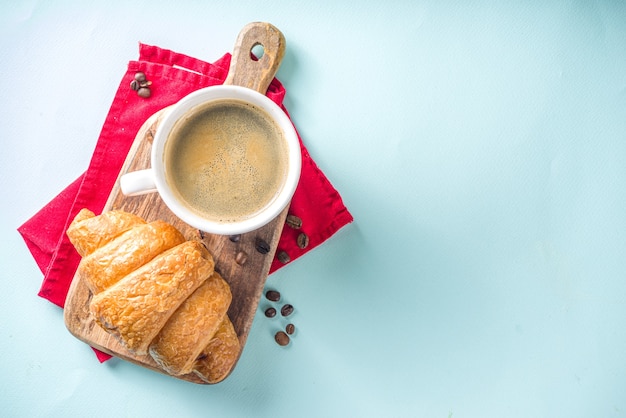 Top view coffee and croissant on table