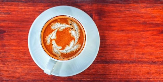 Top view of coffee cup on wooden table