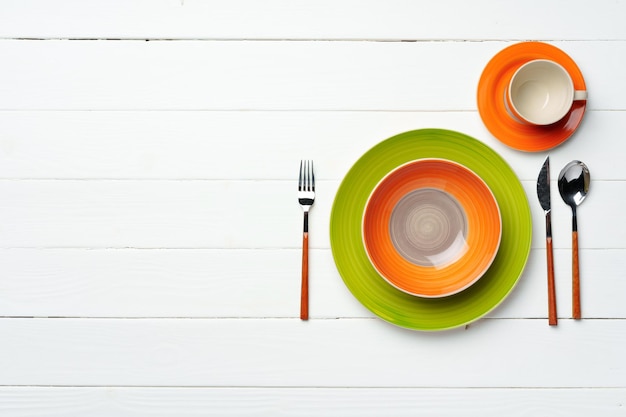 Top view of color ceramic plate on wooden background