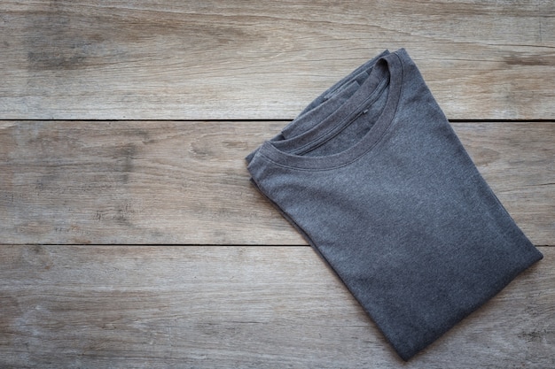 Top view of color T-Shirt on grey wood plank background