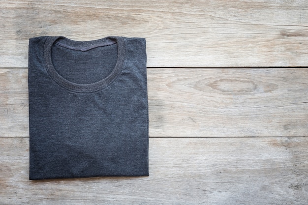 Top view of color T-Shirt on grey wood plank background