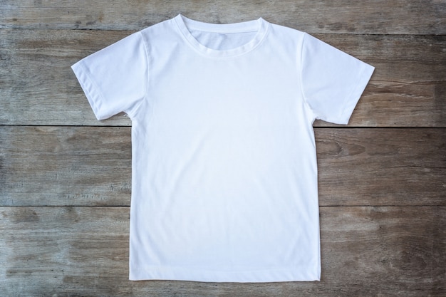 Top view of color T-Shirt on grey wood plank background