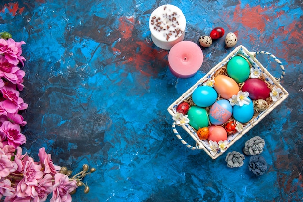 top view colored easter eggs inside cute box on blue surface