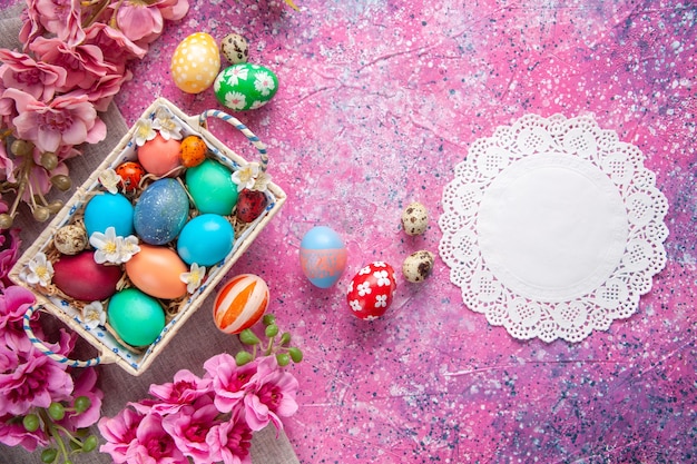 top view colored easter eggs inside cute box with flowers on pink surface colour concept colourful ornate holiday spring easter