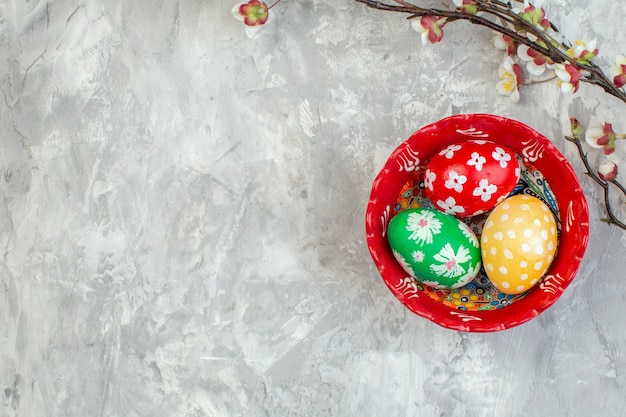 top view colored easter eggs inside plate on white surface