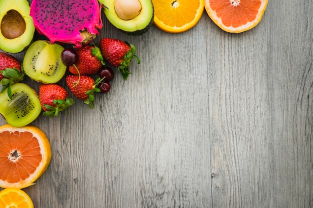 Top view of colored fruits with blank space